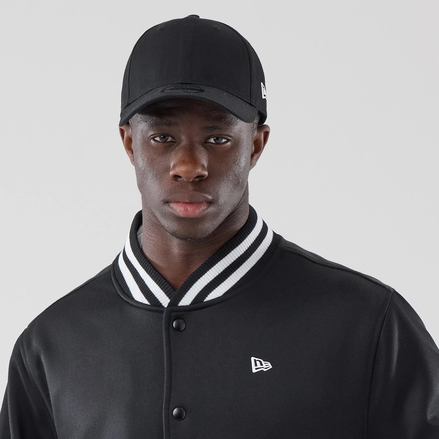 The model is wearing this New Era Jersey Bomber Jacket in black. 7