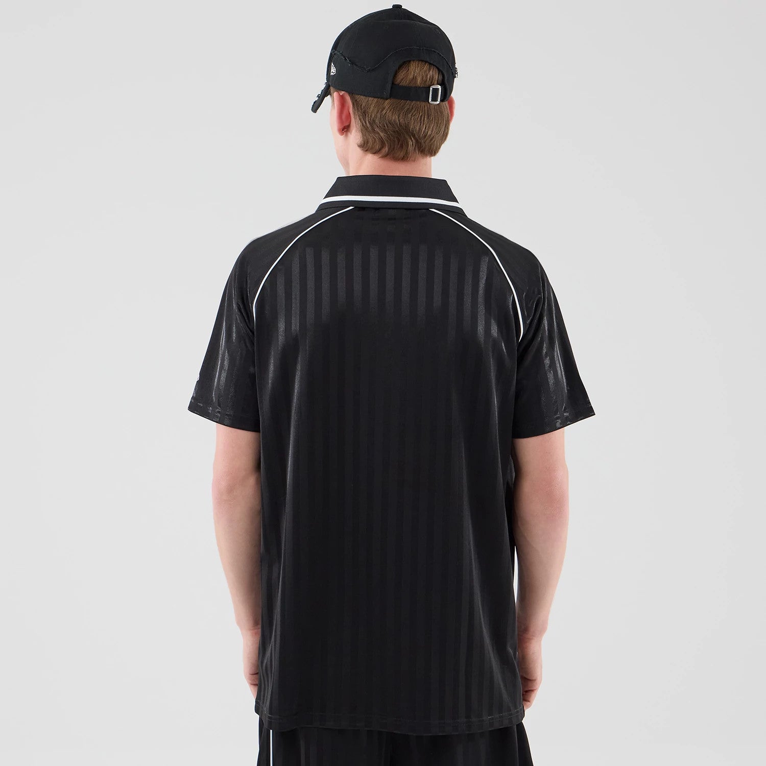 The model is wearing this New Era Football Jersey T-Shirt in black. 2