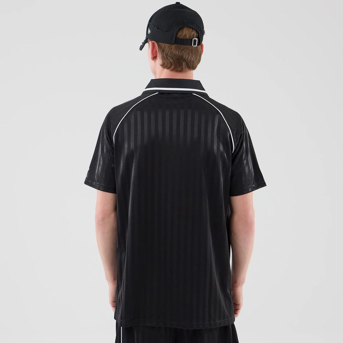 The model is wearing this New Era Football Jersey T-Shirt in black. 2