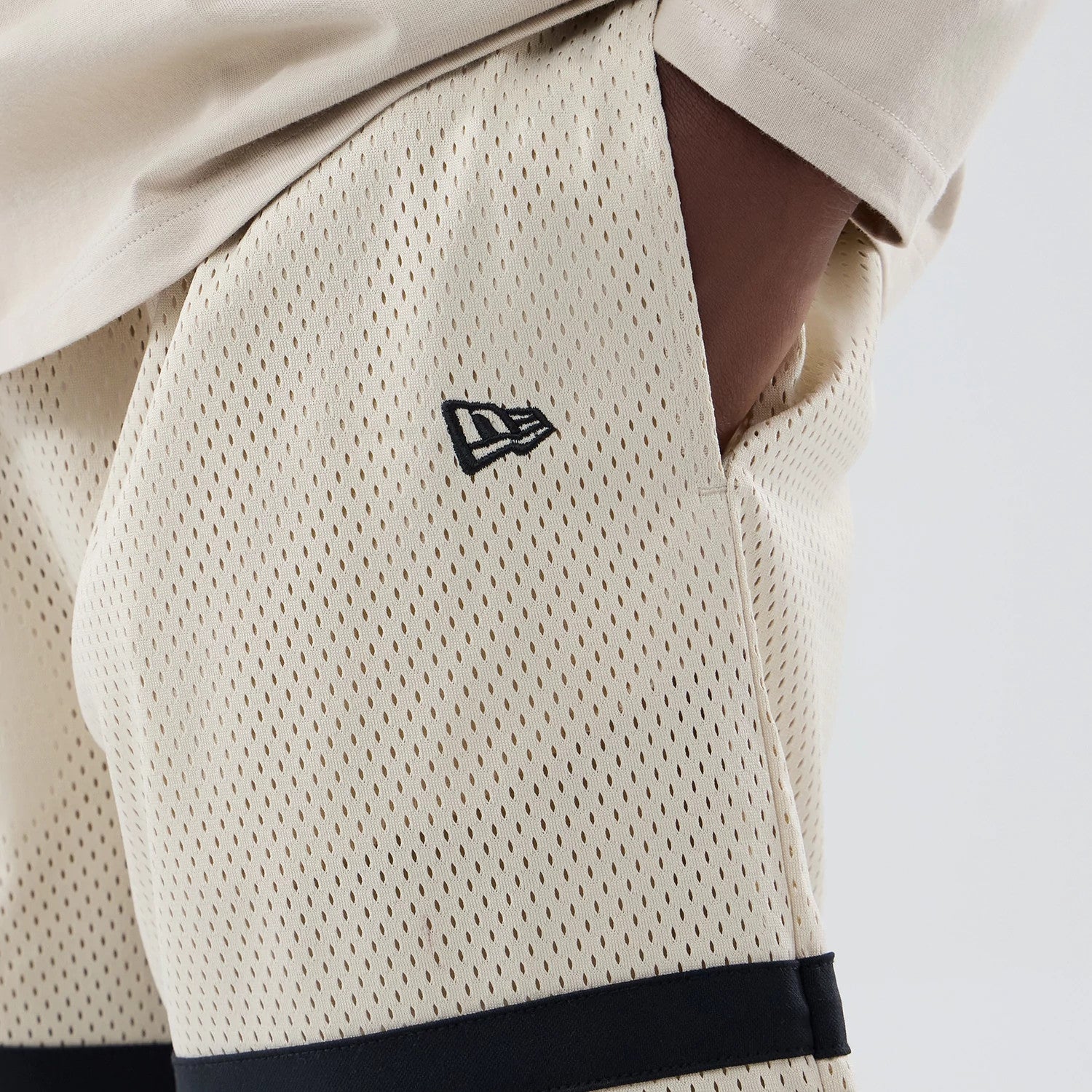 The model is wearing these MLB New York Yankees Oversized Mesh Shorts in light beige. 4