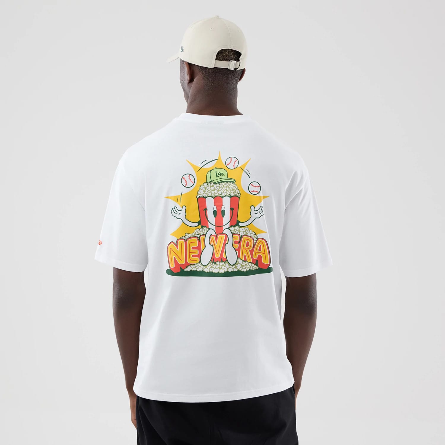 The model is wearing this New Era Food Graphic Oversized T-Shirt in white. 2