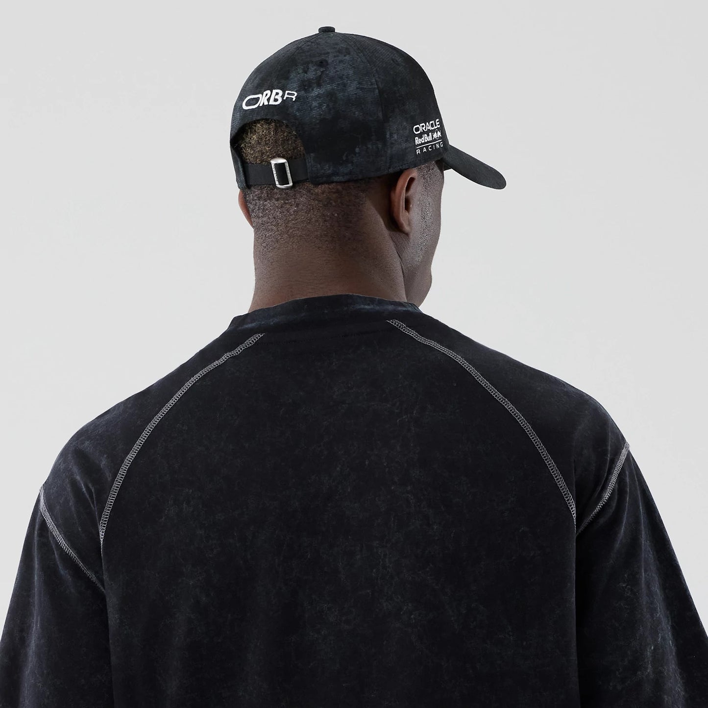 The model is wearing this Red Bull Racing Drop Shoulder T-Shirt in black. 7