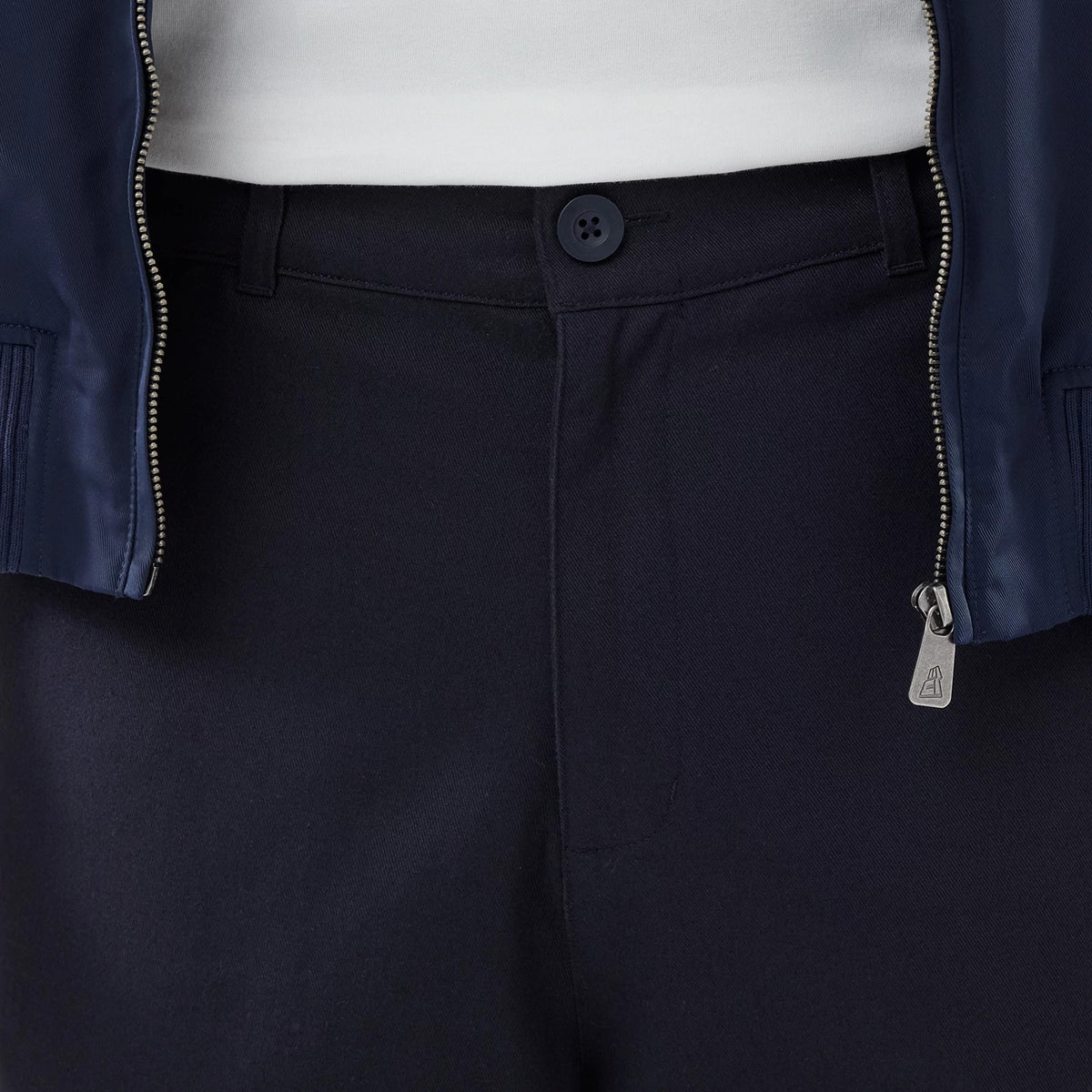 The model is wearing these New Era Chino Trousers in navy. 4