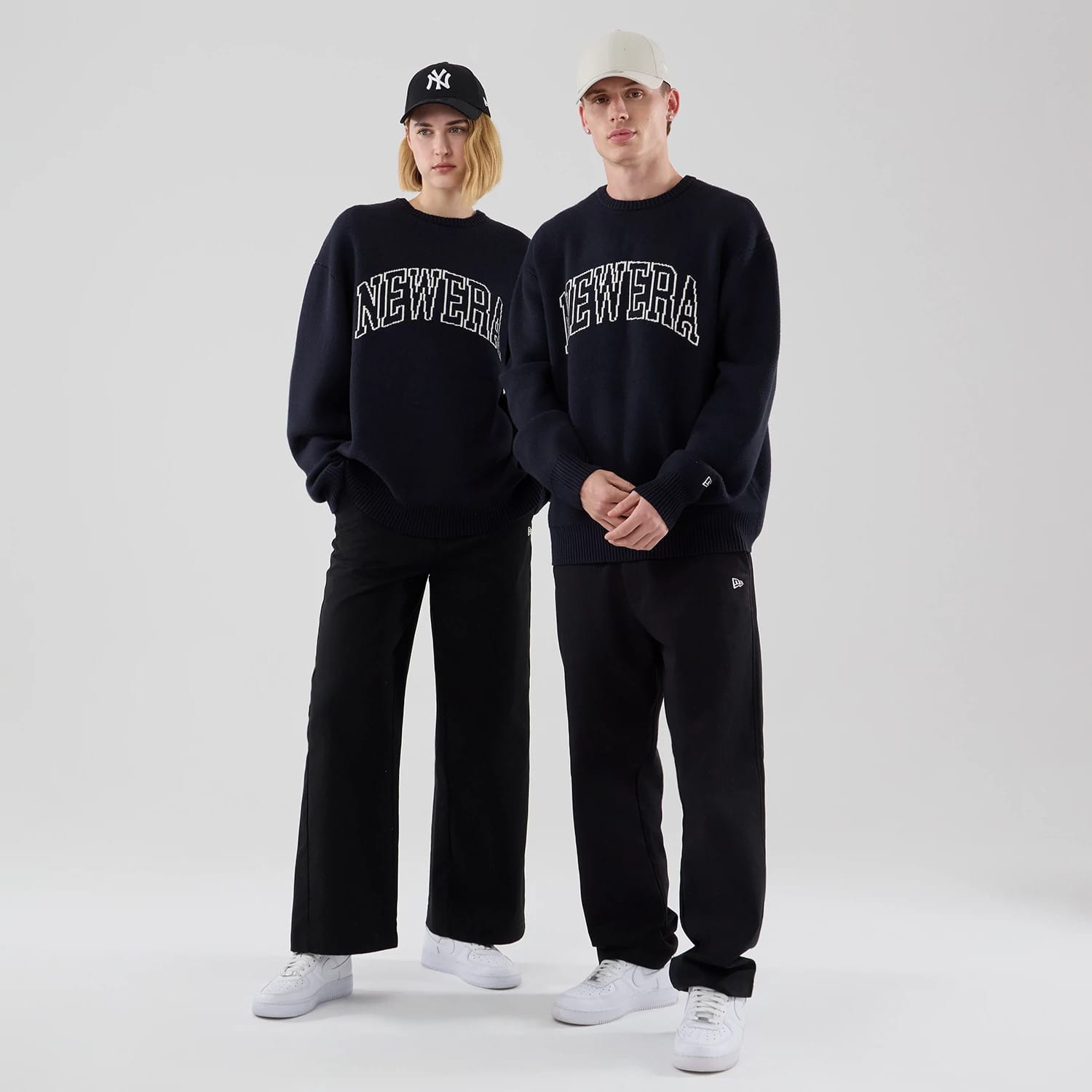 The model is wearing this New Era Knit Knitted Sweater in navy. 1