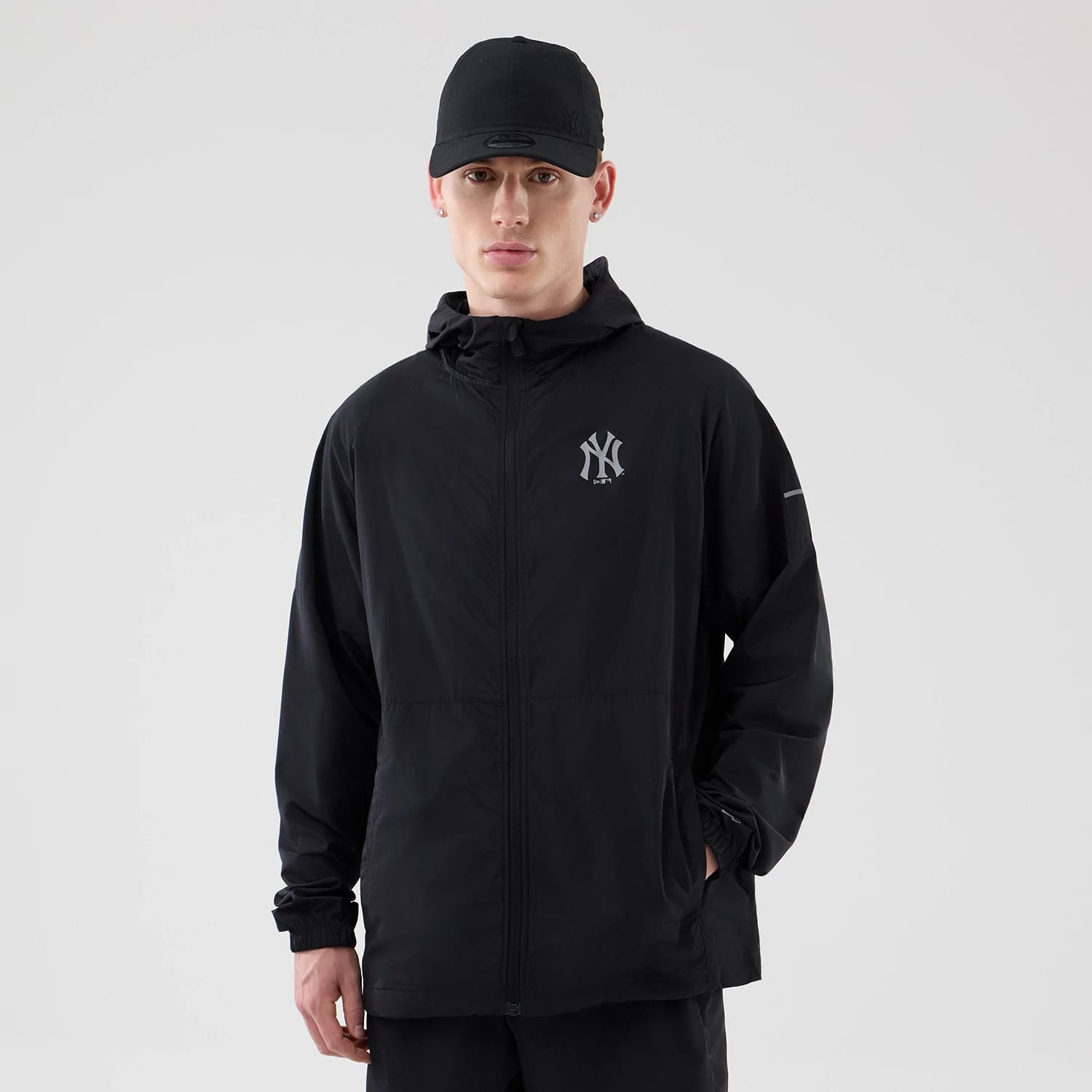 The model is wearing this MLB Core Plus Windbreaker New York Yankees Jacket in black. 1