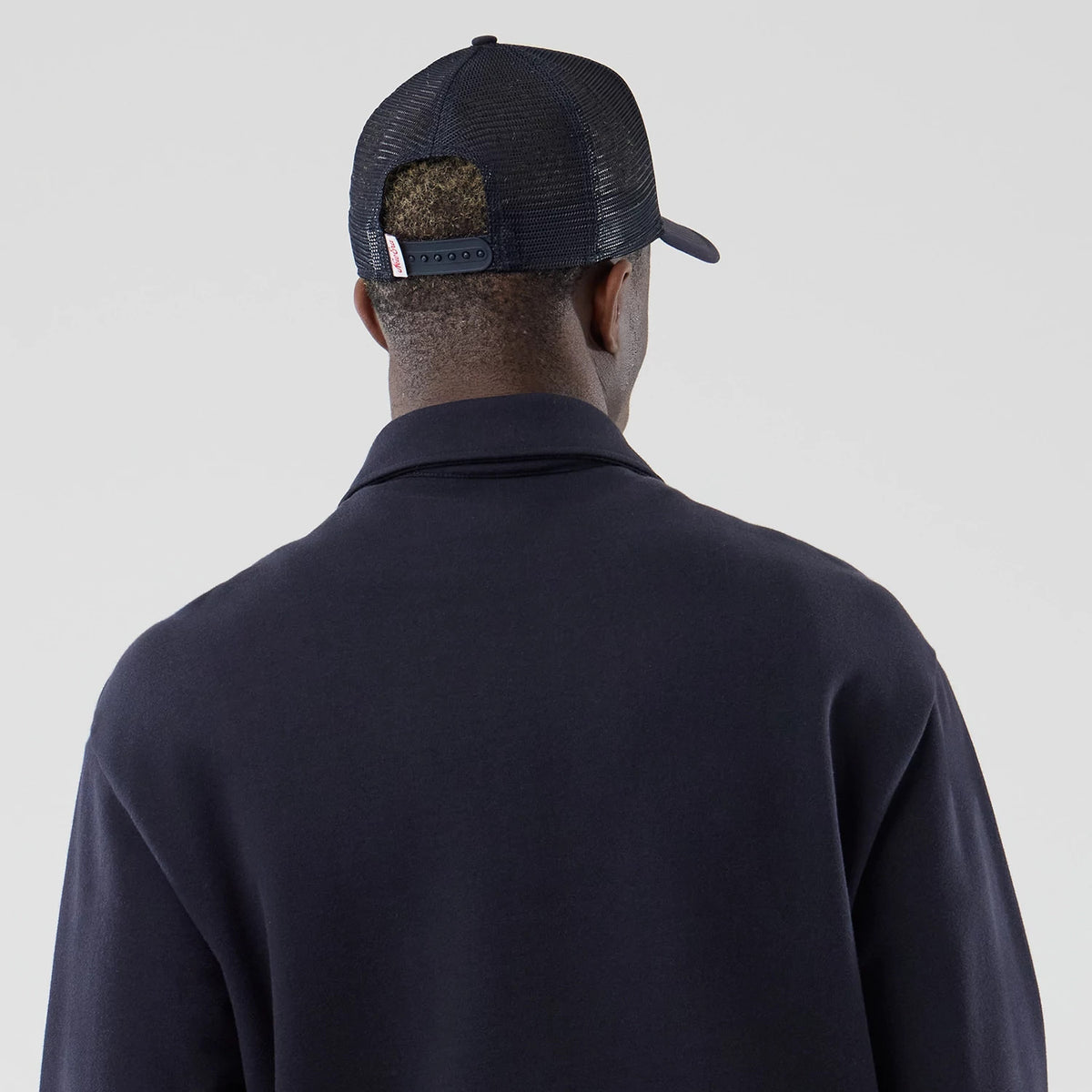 New Era LA Dodgers MLB Navy Oversized 1/4 Zip Sweater, back view on a model wearing a navy cap showing the mesh design of the cap's back panels with an adjustable strap and embroidered label on the closure.