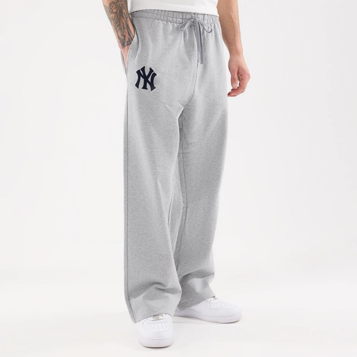 The model is wearing these MLB Straight Leg New York Yankees Straight Leg Joggers in grey. 1