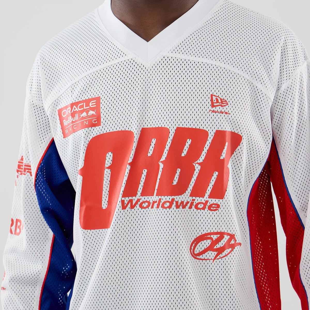 New Era Red Bull Racing White Hockey Jersey, front view on a model showing the prominent red ORBR worldwide graphic on the chest, the Oracle Red Bull Racing patch on the left shoulder, and the New Era flag logo on the right chest.