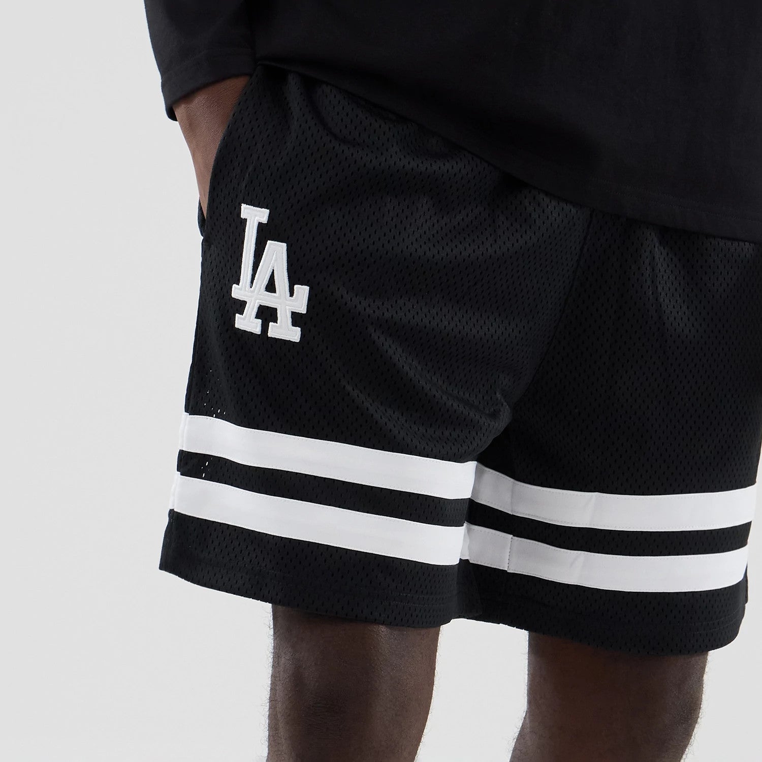The model is wearing these MLB Mesh LA Dodgers Oversized Shorts in black. 3