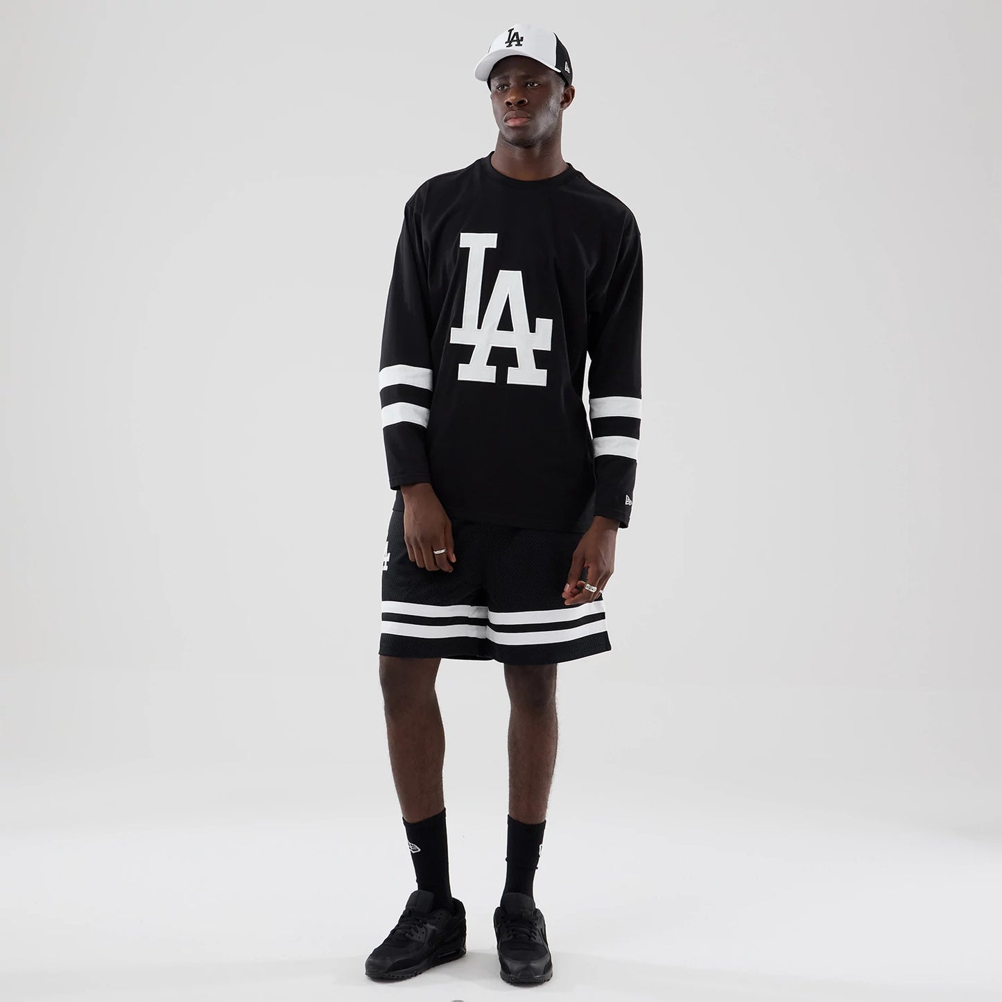 The model is wearing these MLB Mesh LA Dodgers Oversized Shorts in black. 8