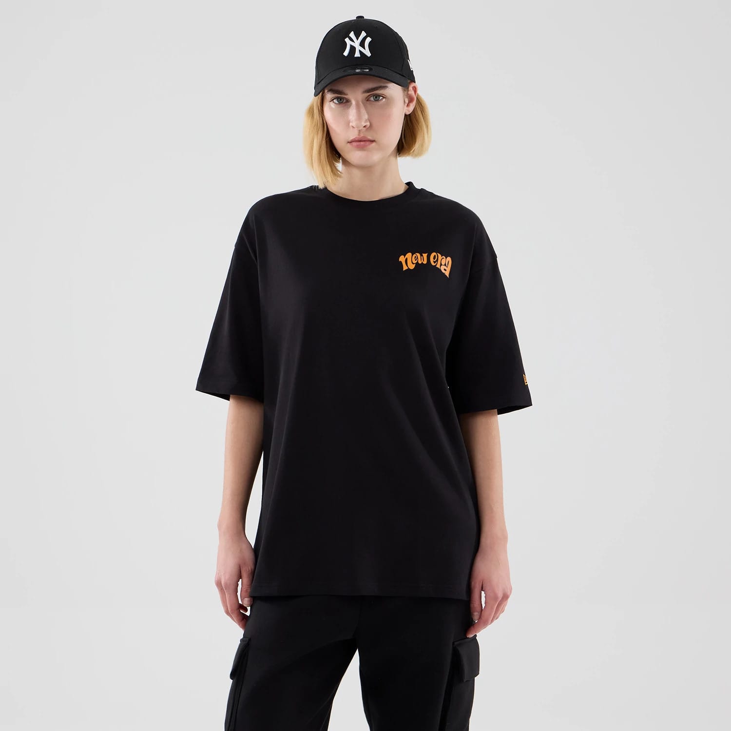 The model is wearing this New Era Hot Dog Graphic Oversized T-Shirt in black. 4
