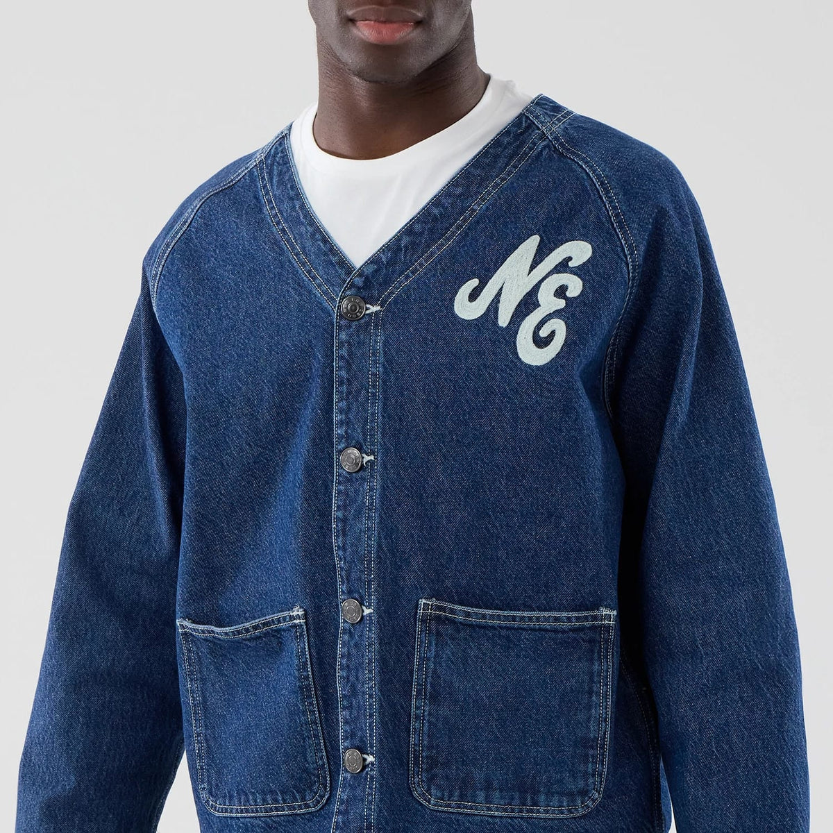 The model is wearing this New Era Denim Worker Jacket in dark blue. 3