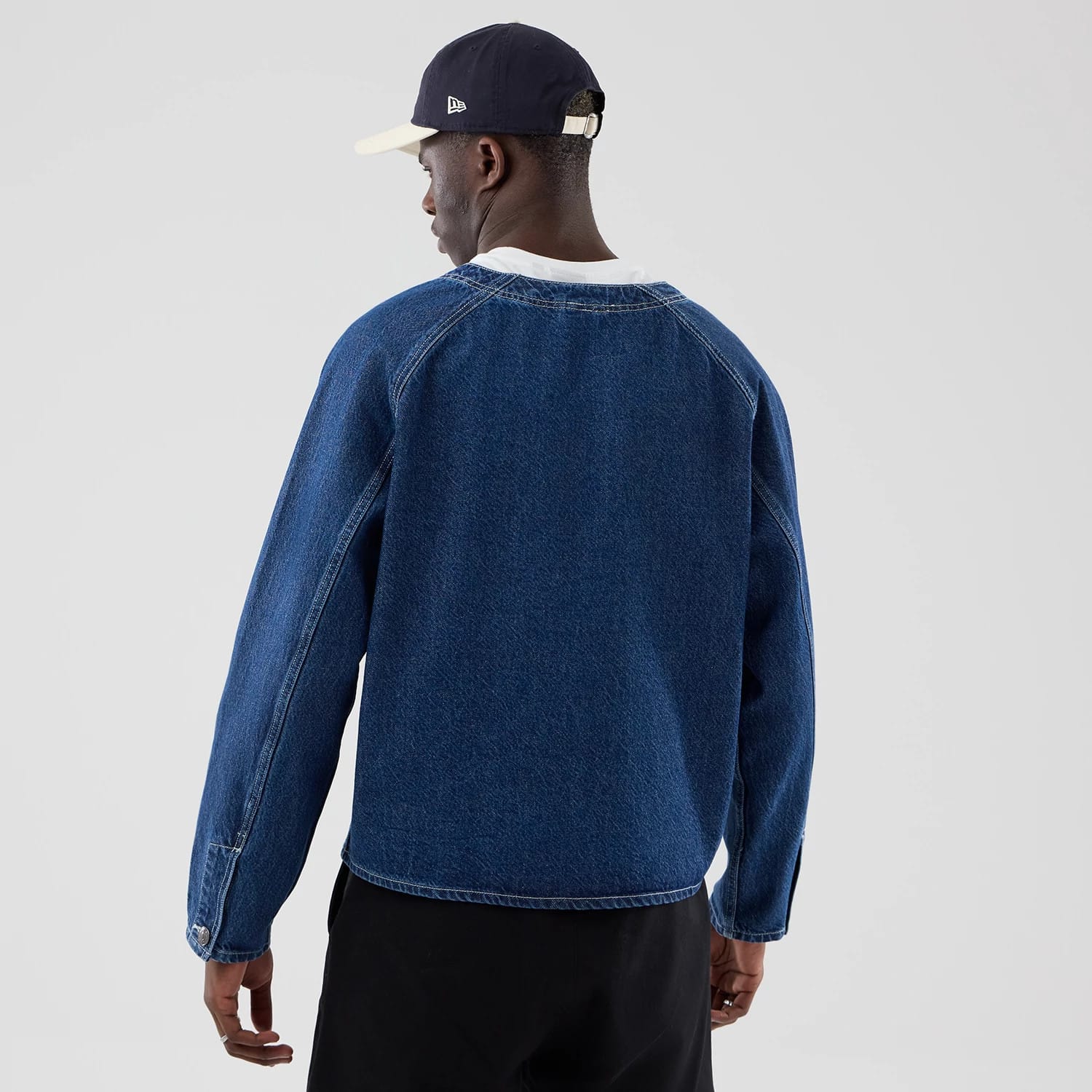 The model is wearing this New Era Denim Worker Jacket in dark blue. 2