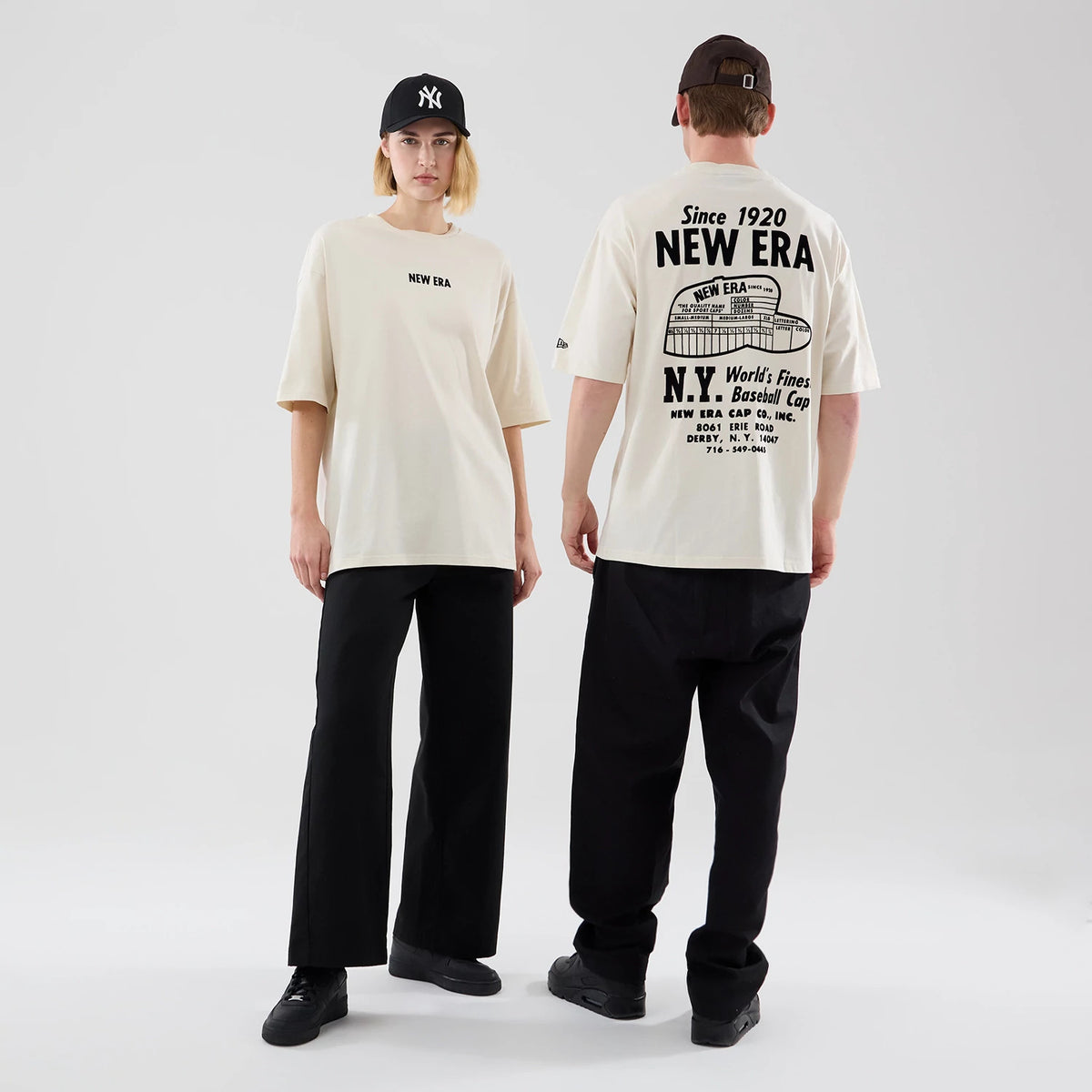 The model is wearing this New Era Cap Graphic Oversized T-Shirt in cream. 1