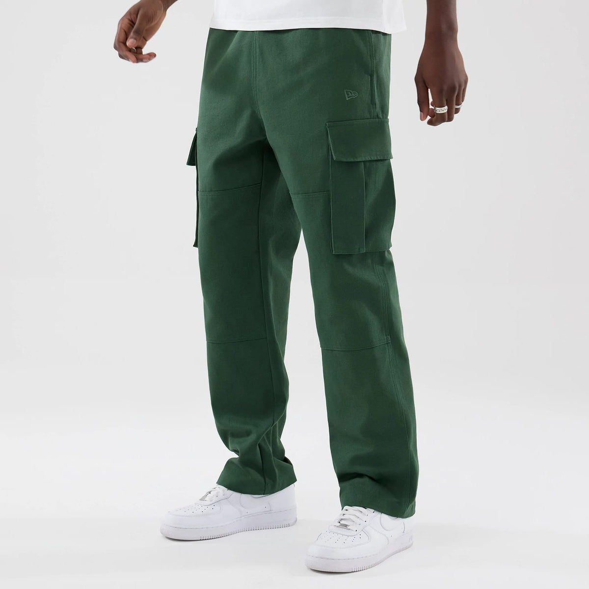 The model is wearing these New Era Cargo Trousers in dark green. 3