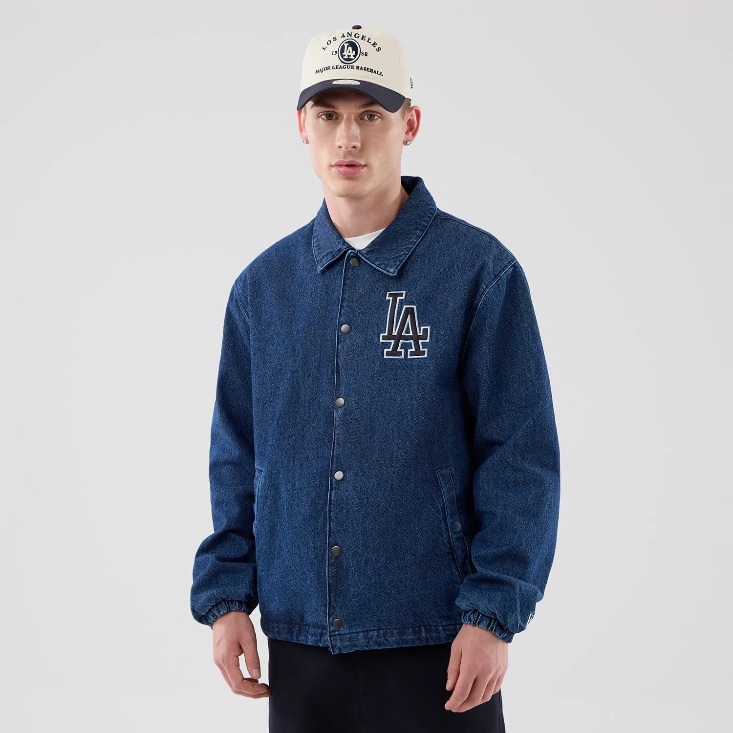 The model is wearing this MLB Coaches LA Dodgers Jacket in dark blue. 1