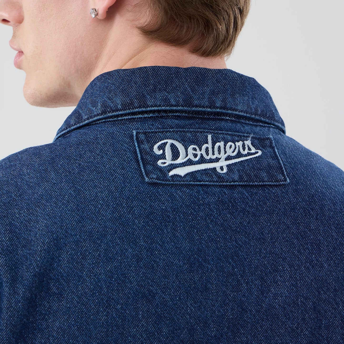 The model is wearing this MLB Coaches LA Dodgers Jacket in dark blue. 7
