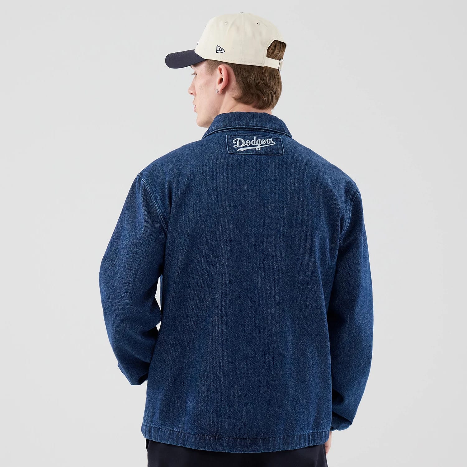 The model is wearing this MLB Coaches LA Dodgers Jacket in dark blue. 2