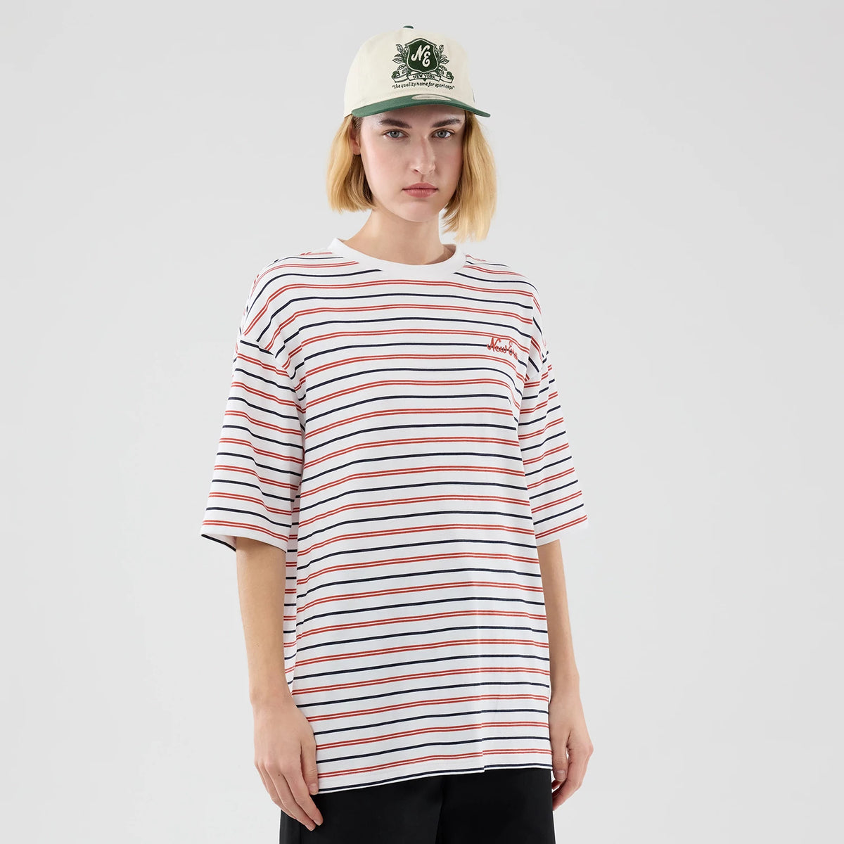 The model is wearing this New Era Stripe Oversized T-Shirt in white. 4