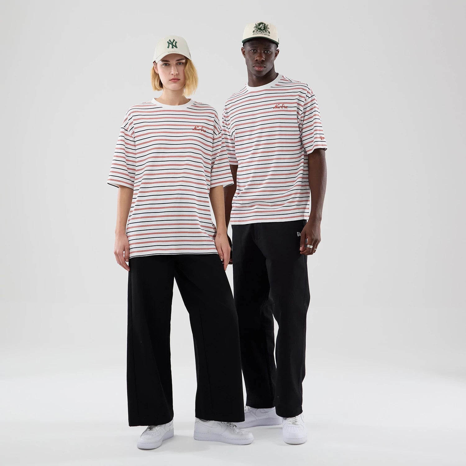 The model is wearing this New Era Stripe Oversized T-Shirt in white. 1