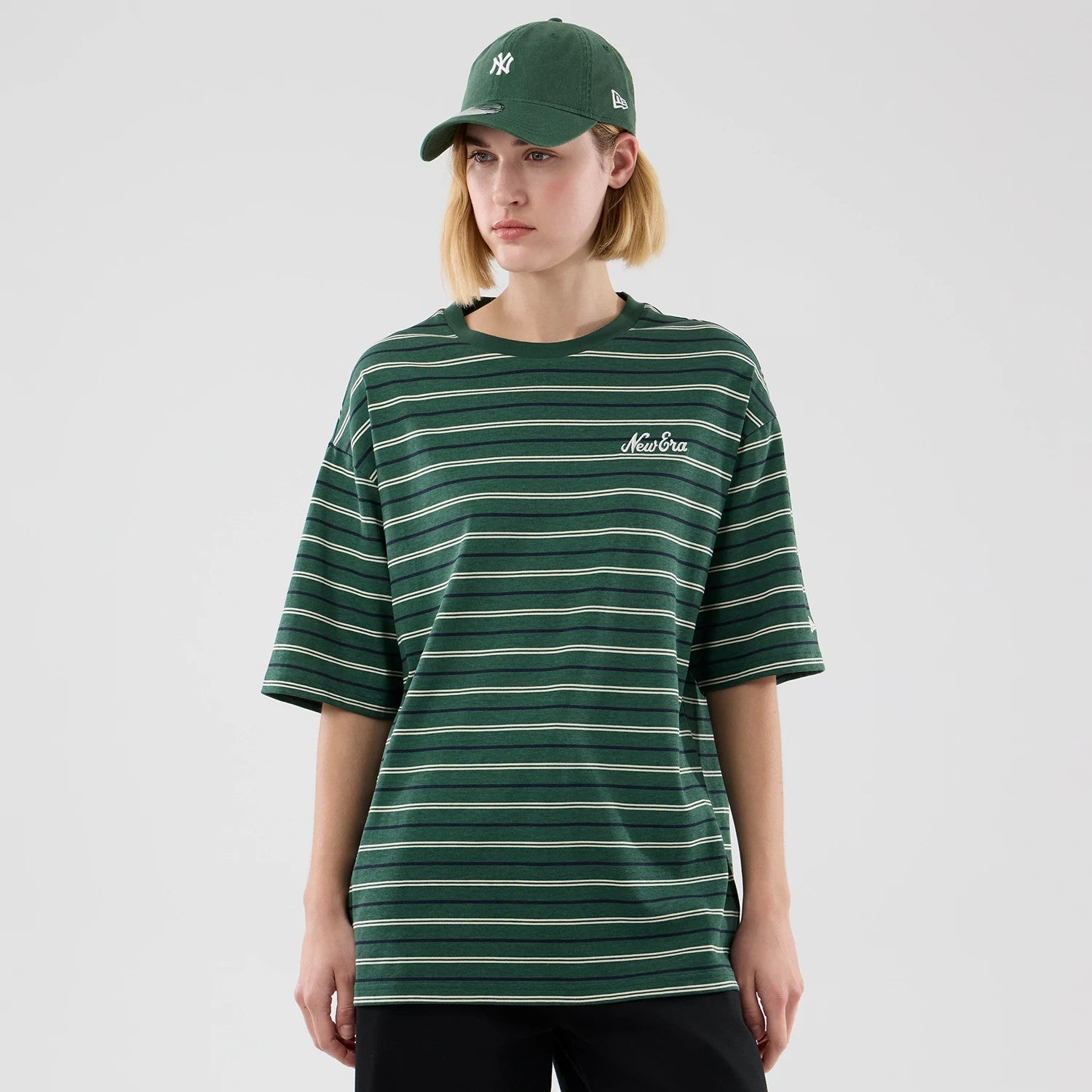 The model is wearing this New Era Stripe Oversized T-Shirt in dark green. 4