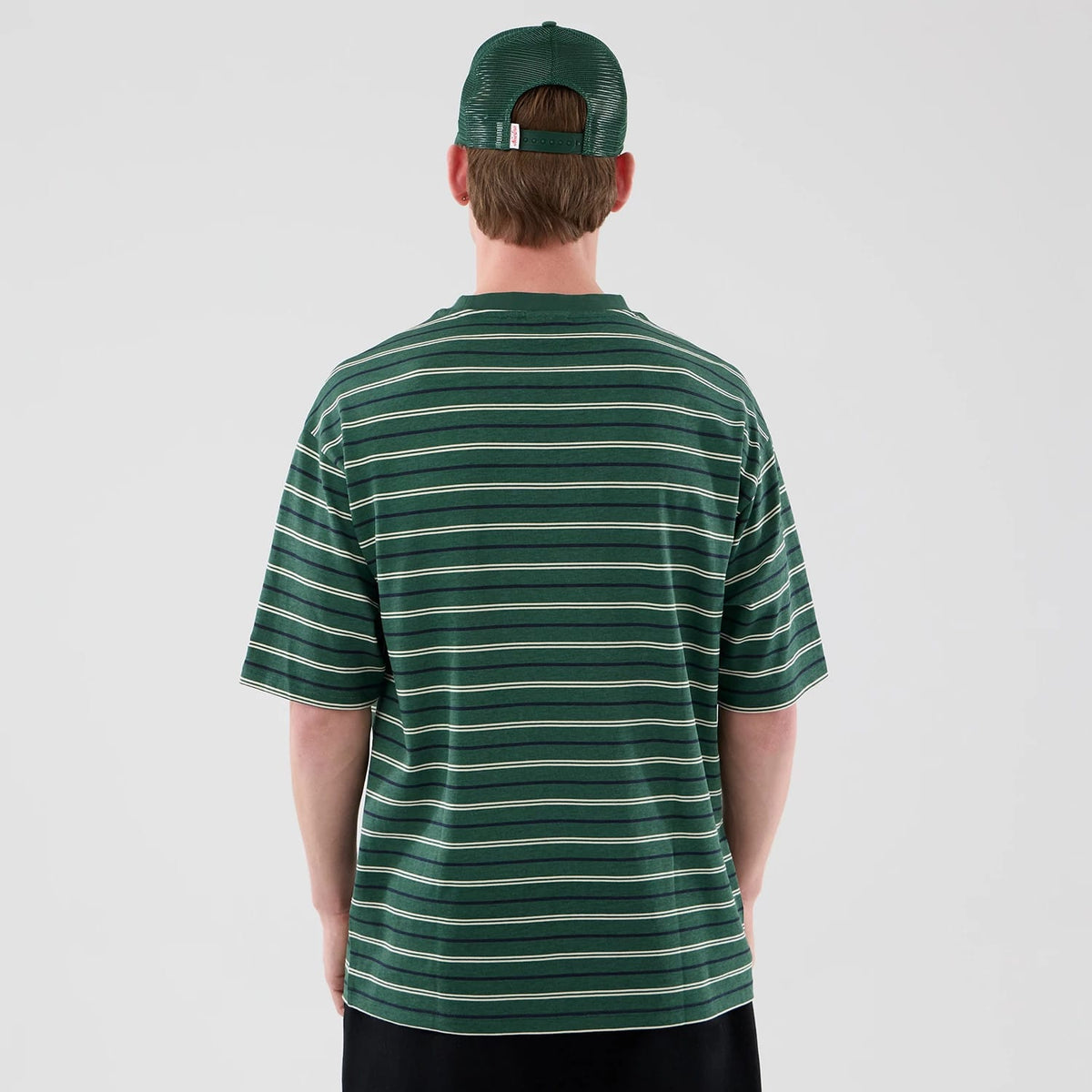 The model is wearing this New Era Stripe Oversized T-Shirt in dark green. 2