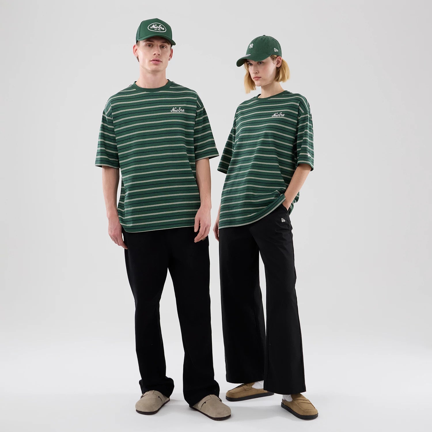The model is wearing this New Era Stripe Oversized T-Shirt in dark green. 1