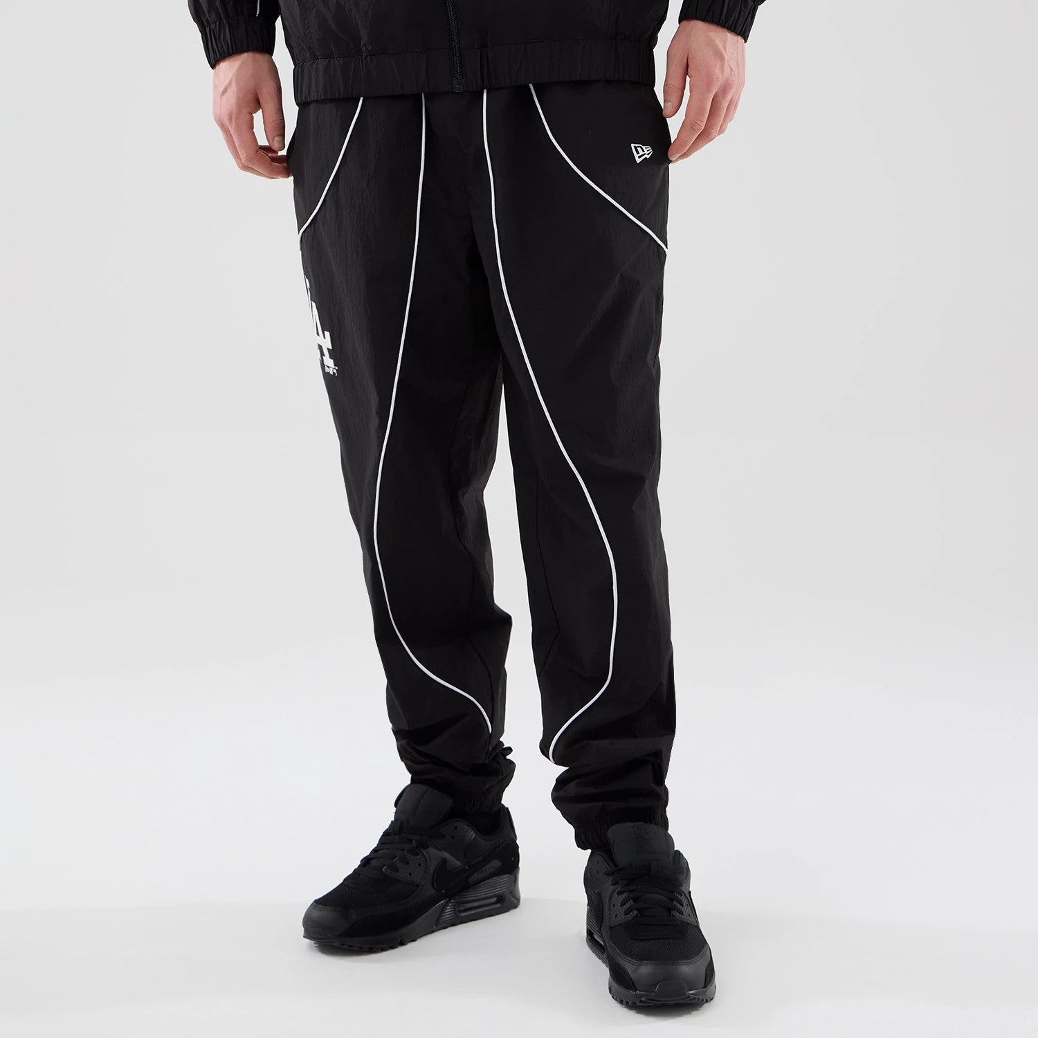 The model is wearing these MLB Piping Track LA Dodgers Track Pants in black. 1