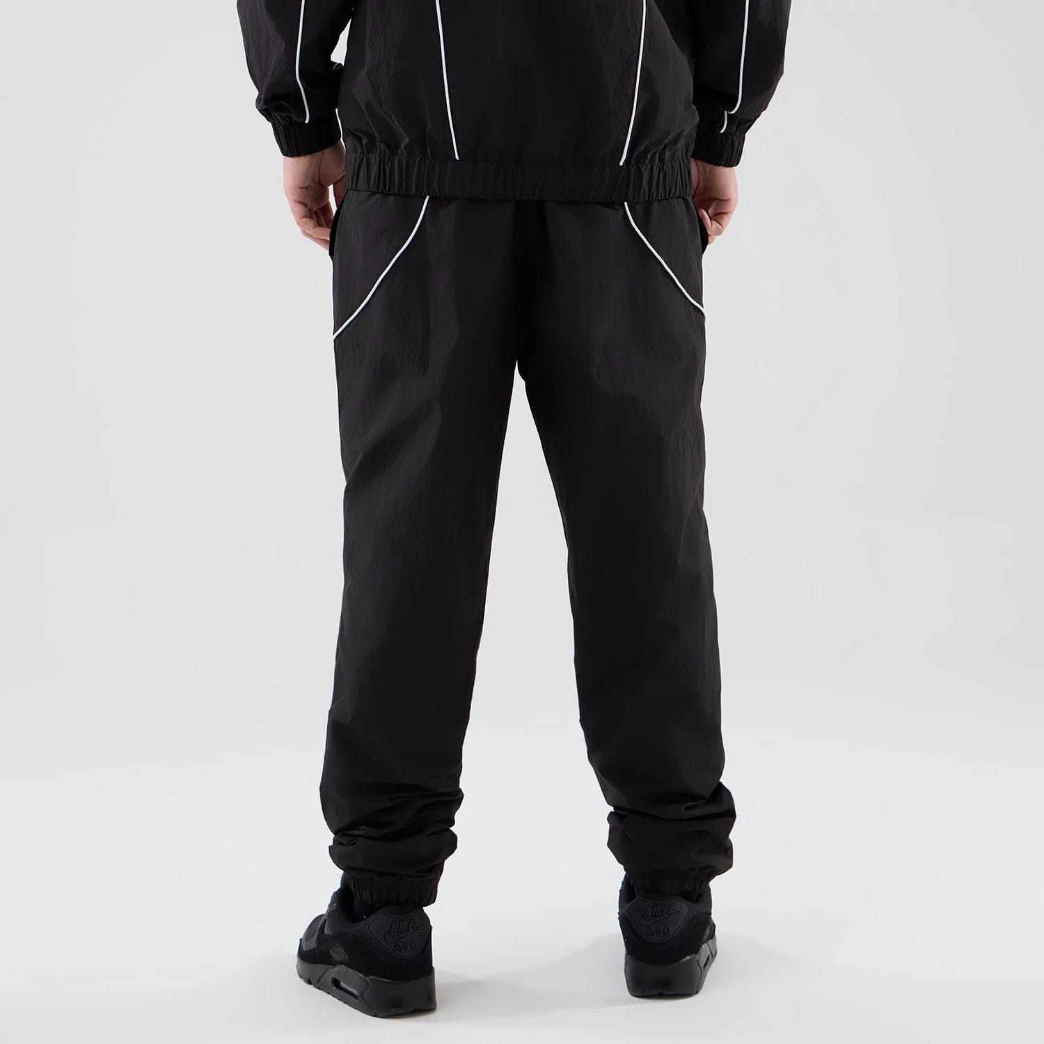 The model is wearing these MLB Piping Track LA Dodgers Track Pants in black. 2
