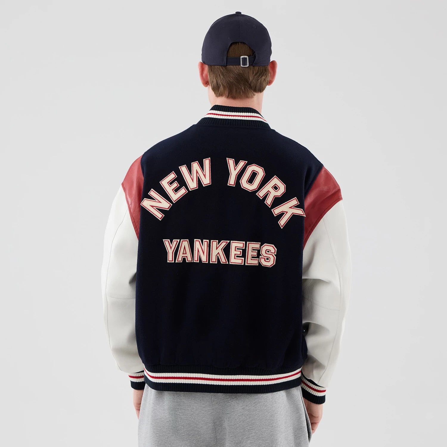 The model is wearing this MLB Varsity New York Yankees Jacket in navy. 2
