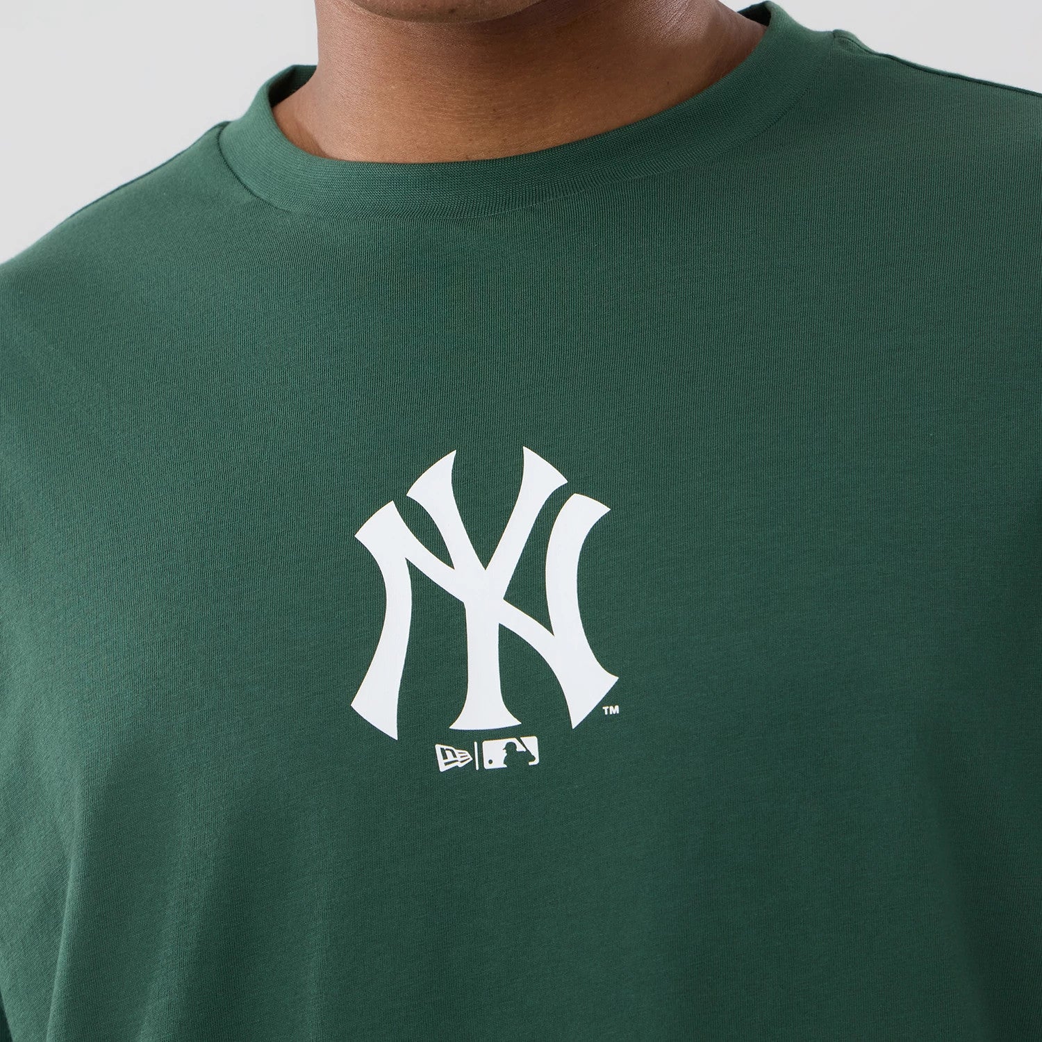 The model is wearing this MLB Food Graphic New York Yankees Oversized T-Shirt in dark green. 4
