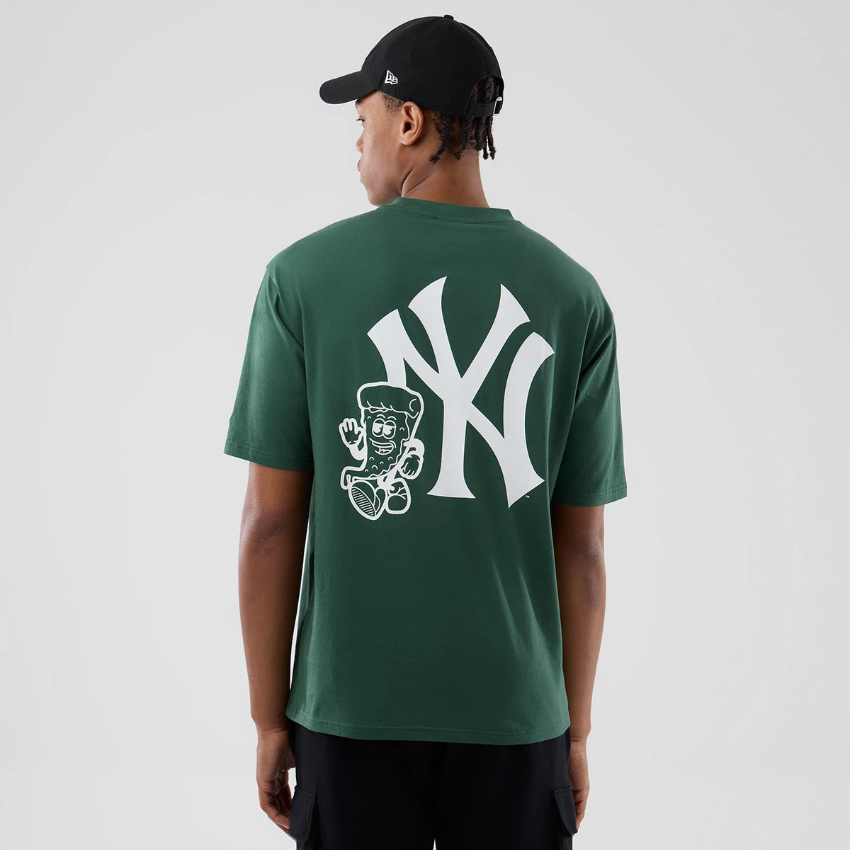 New Era New York Yankees MLB Food Graphic Dark Green Oversized T-Shirt, back view on a model wearing a black cap, showing a large white embroidered Yankees logo centred on the dark green fabric.