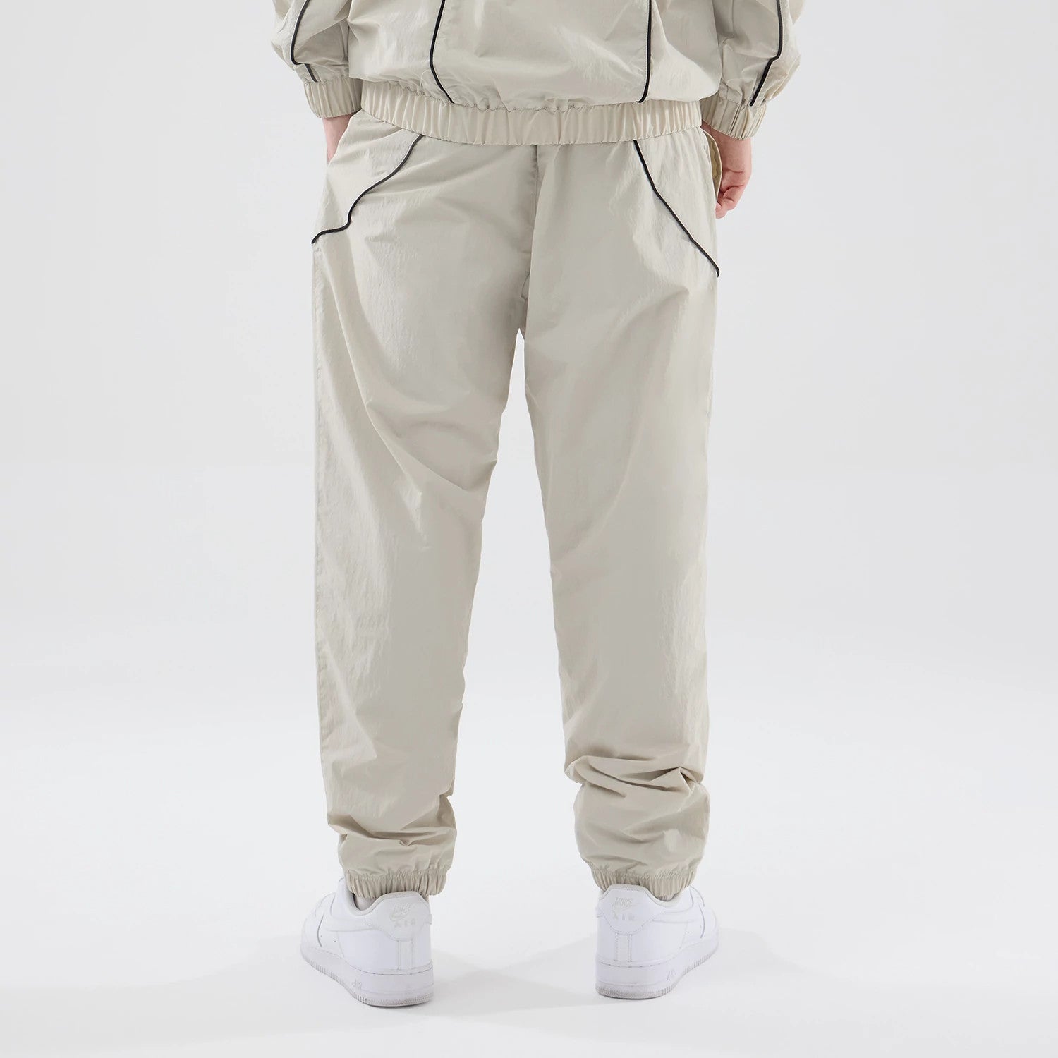 The model is wearing these MLB Piping Track New York Yankees Track Pants in cream. 2