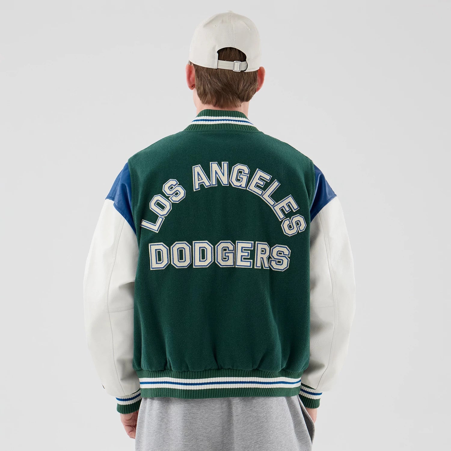 The model is wearing this MLB Varsity LA Dodgers Jacket in dark green. 2