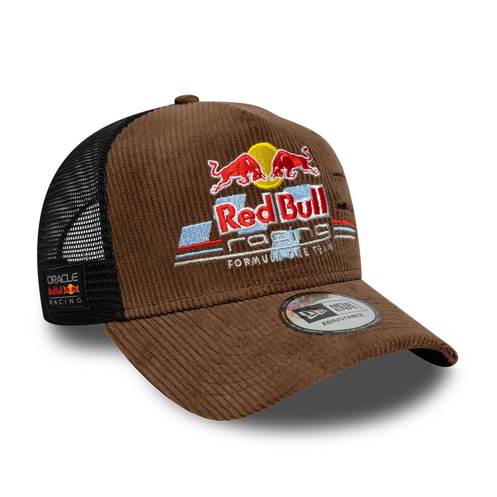 Red Bull Racing Distressed Cord Brown New Era 9FORTY A-Frame Trucker Adjustable Cap, three-quarter view showing raised embroidered Red Bull Racing logo on the brown cord front panel, black mesh rear, and 9FORTY size sticker on the brown visor.