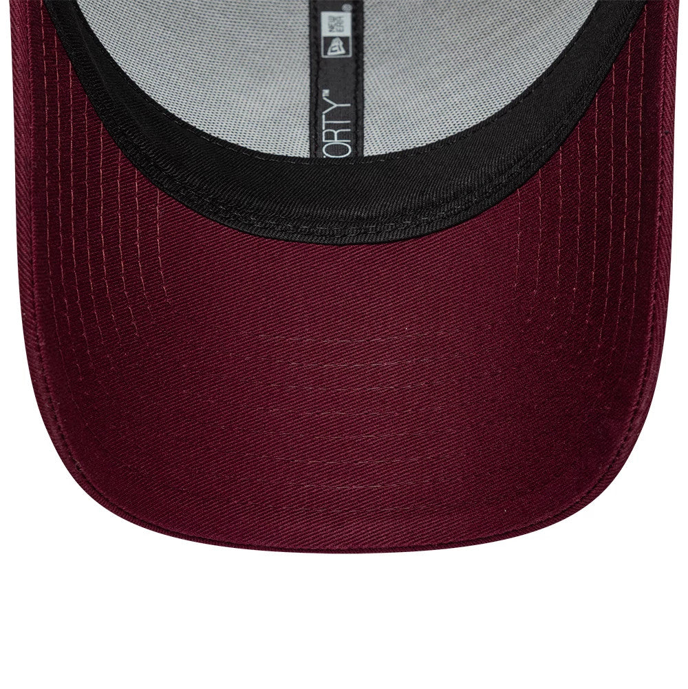 Manchester United FC Dark Red New Era 9FORTY Adjustable Cap, inside view showing the black sweatband against the dark red undervisor, with internal taping featuring the 9FORTY label text running along the centre.