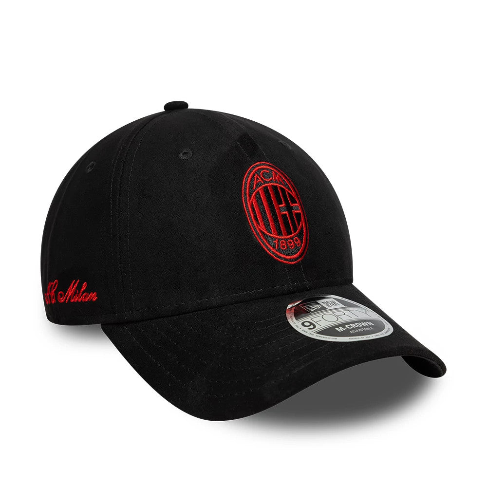 AC Milan Faux Suede Black New Era 9FORTY M-Crown Adjustable Cap, three-quarter view showing the red embroidered AC Milan logo on the front panel, black curved visor with a 9FORTY size sticker, and cursive AC Milan embroidery on the side.
