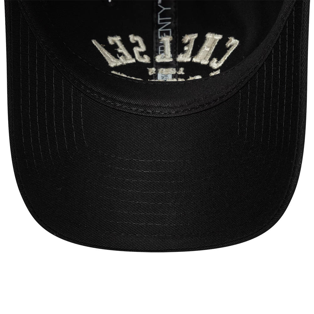 Chelsea FC Script Black New Era 9TWENTY Adjustable Cap, inside view showing the black undervisor, the embroidered Chelsea script upside down on the inside front panel, and the black sweatband along with the white New Era taping.