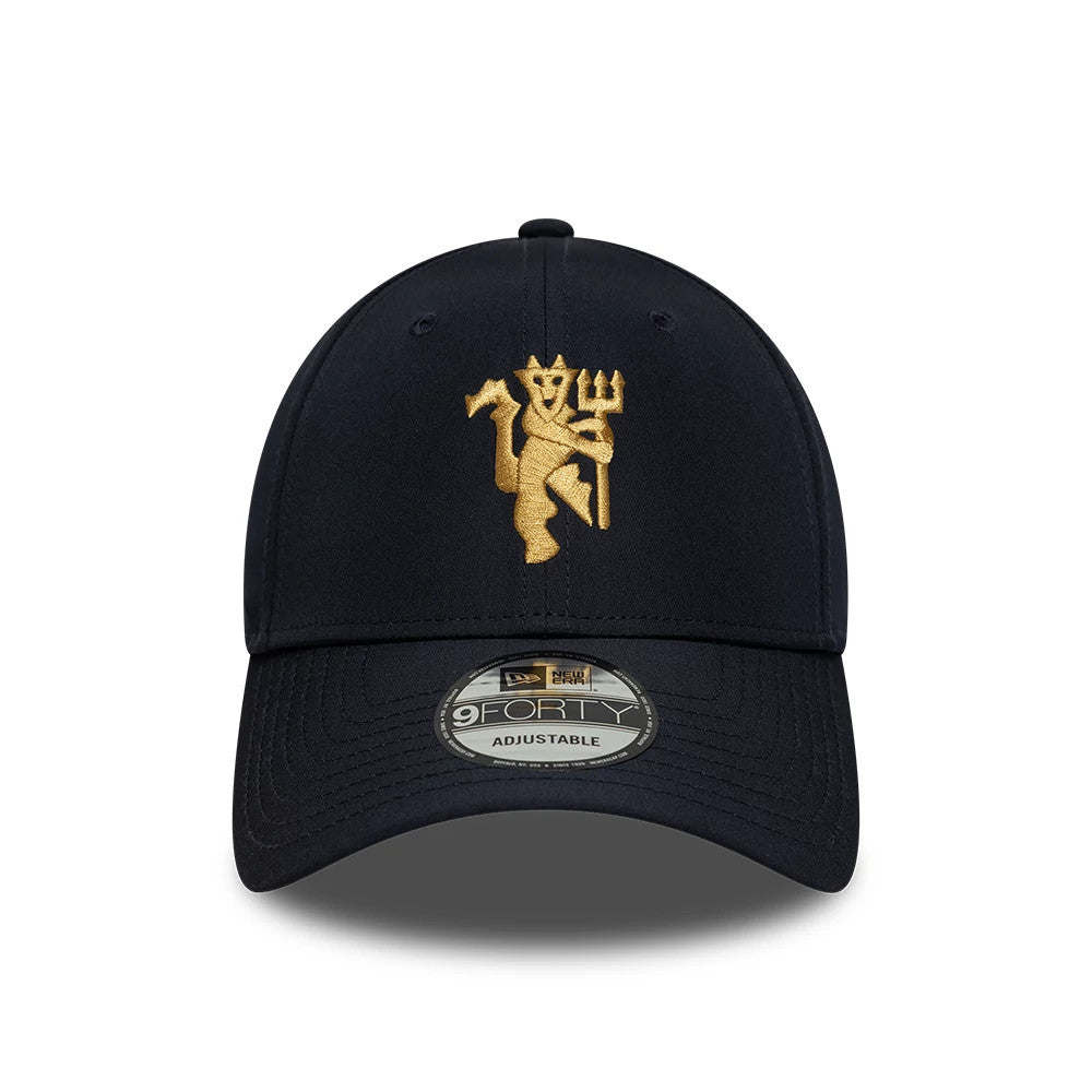 Manchester United FC Gold Navy New Era 9FORTY Adjustable Cap, front view showing the gold embroidered Manchester United crest on the front panel, navy curved visor, and a 9FORTY size sticker on the visor.