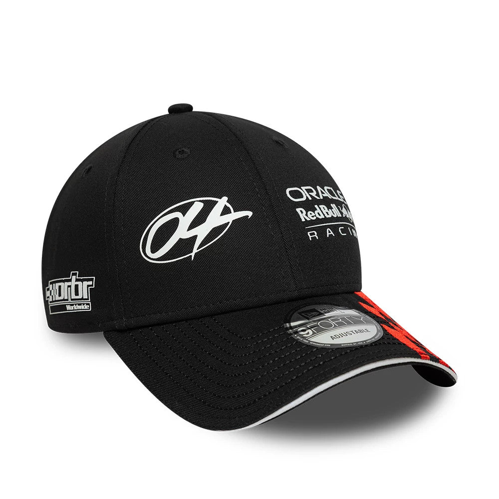 Red Bull Racing Visor Graphic Black New Era 9FORTY Adjustable Cap, three-quarter view showing a white embroidered graphic on the front panel, a black visor with distinctive red accents, and a 9FORTY size sticker on the central visor.