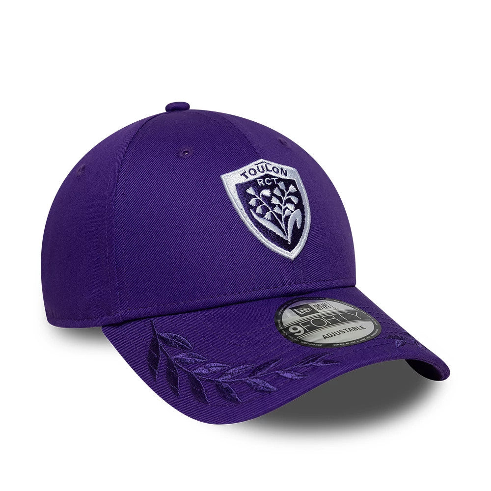Rugby Club Toulon Laurel Dark Purple New Era 9FORTY Adjustable Cap, three-quarter view showing the white embroidered Toulon RCT logo on the front panel, with laurel embroidery along the dark purple curved visor and the 9FORTY size sticker on top.