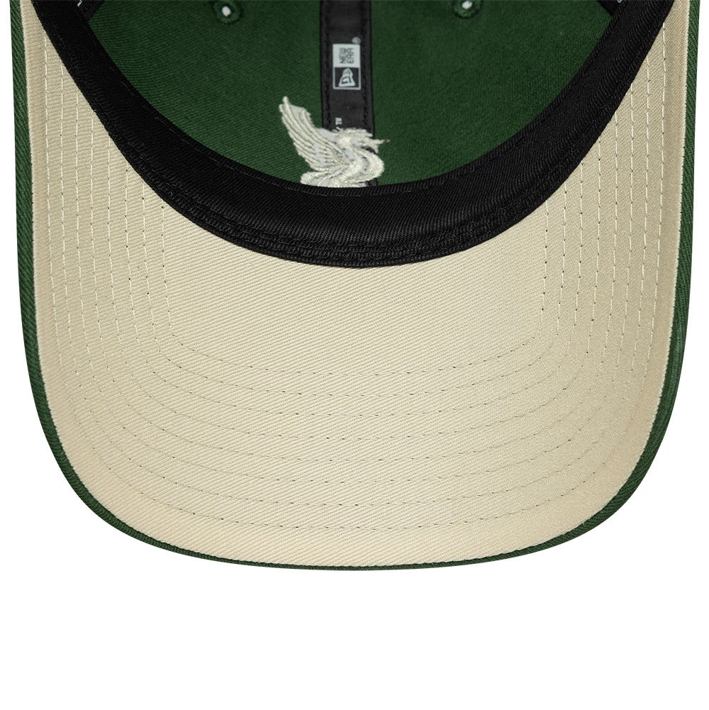 Liverpool FC Dark Green New Era 9TWENTY Adjustable Cap, inside view showing a black sweatband against the green crown, a cream undervisor with stitching, and internal black taping featuring white branding and an embroidered logo.