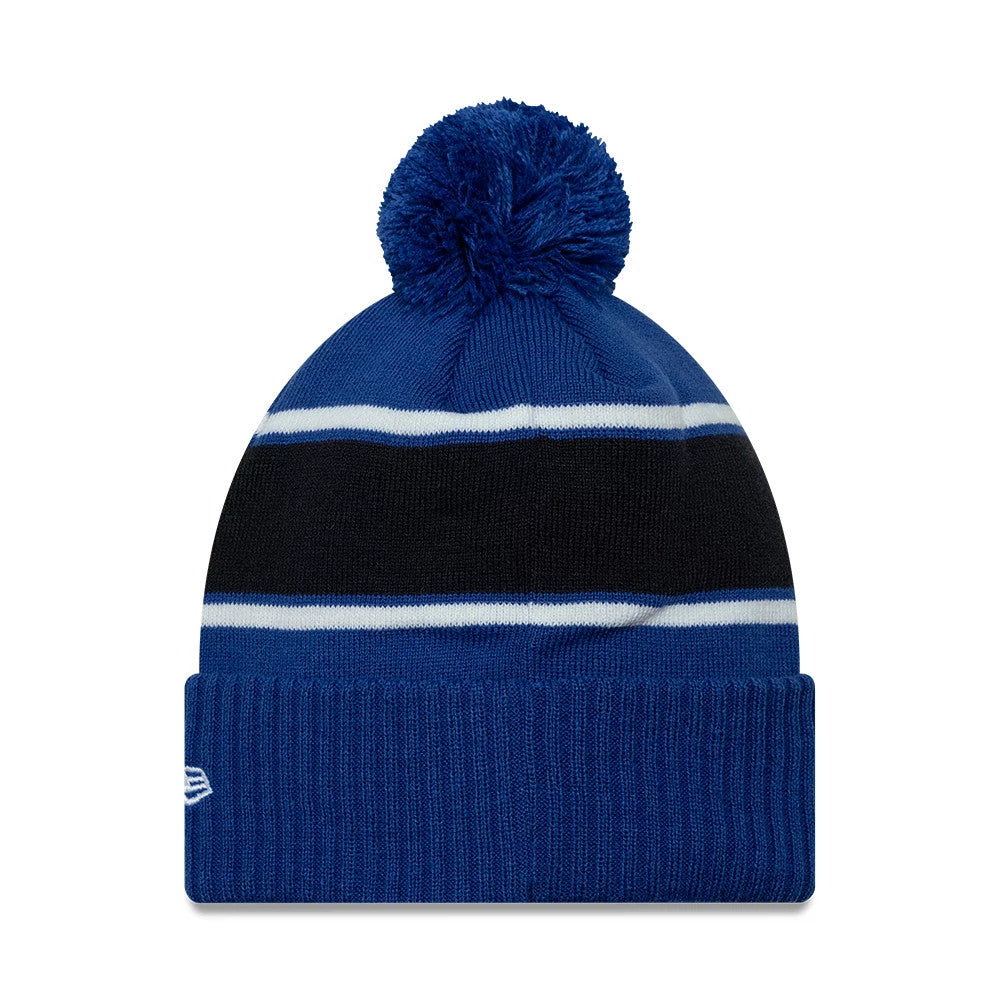 New Era FC Porto Blue Cuff Knit Beanie Hat, front view showing a large blue pom-pom on top, with horizontal black and white stripes around the crown, and a folded blue cuff featuring the white embroidered New Era flag logo on the side.