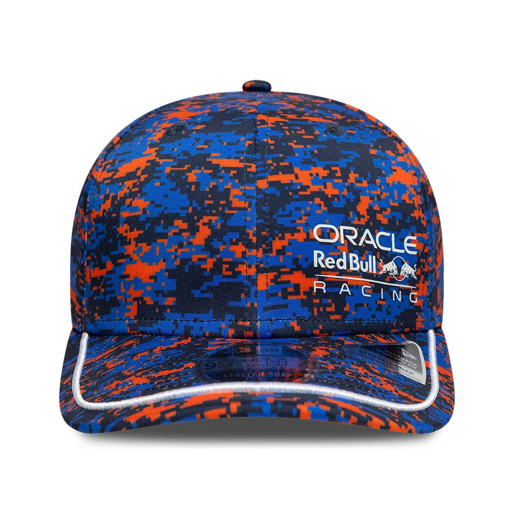 Red Bull Racing Digi Camo Dark Blue New Era 9SEVENTY Stretch Snap Adjustable Cap, front view showing the embroidered Oracle Red Bull Racing logo on the front panel, a digi camo pattern in dark blue and orange.