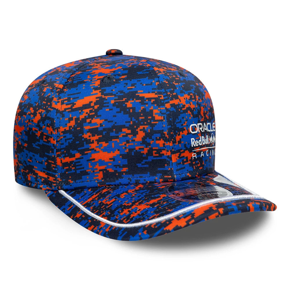 Red Bull Racing Digi Camo Dark Blue New Era 9SEVENTY Stretch Snap Adjustable Cap, three-quarter view with raised white embroidered Oracle Red Bull Racing logo on the front panel, camo pattern in orange and blue.