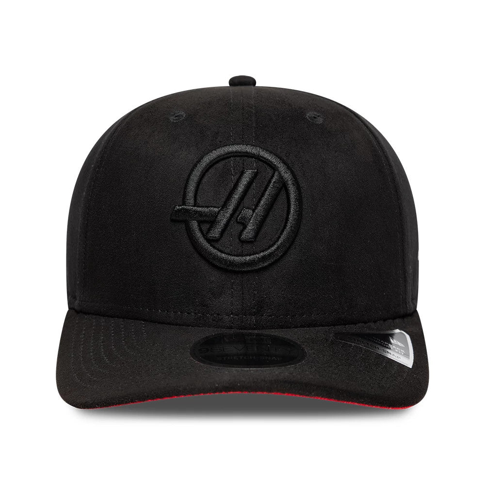 TGR Haas F1 Team Suede Black New Era 9SEVENTY Stretch Snap Adjustable Cap, front view showing the black raised embroidered Haas logo on the centre of the structured black suede crown, with a black visor featuring a 9SEVENTY size sticker.