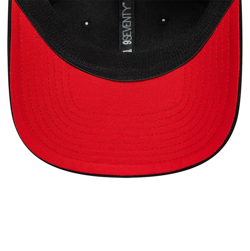 TGR Haas F1 Team Suede Black New Era 9SEVENTY Stretch Snap Adjustable Cap, inside view showing a bright red undervisor, black sweatband, and the black branded taping running across the interior, creating a contrast.