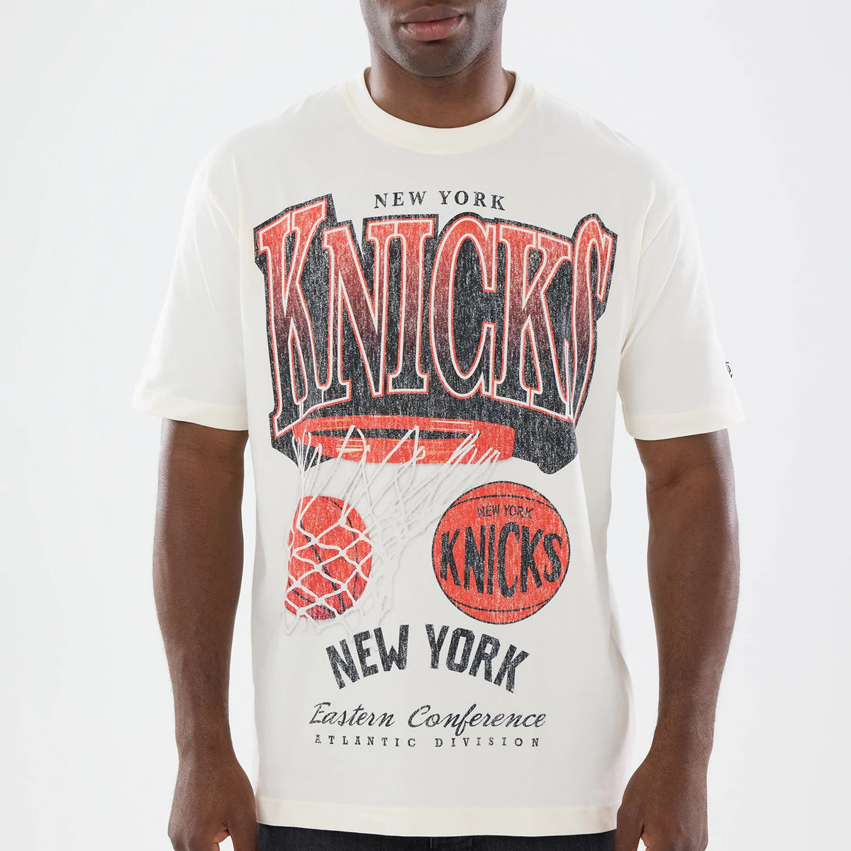 New Era New York Knicks NBA Sport Classic Cream T-Shirt, front view on-model showing red and black Knicks lettering with vintage-style graphic of a basketball and hoop, New York Eastern Conference text.