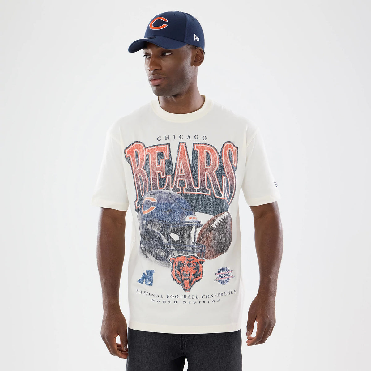 New Era Chicago Bears NFL Sport Classic Cream T-Shirt, front view on-model displaying a large Bears graphic with a football helmet and team logo in the centre, the word BEARS in letters above, and a small embroidered New Era logo on the sleeve.