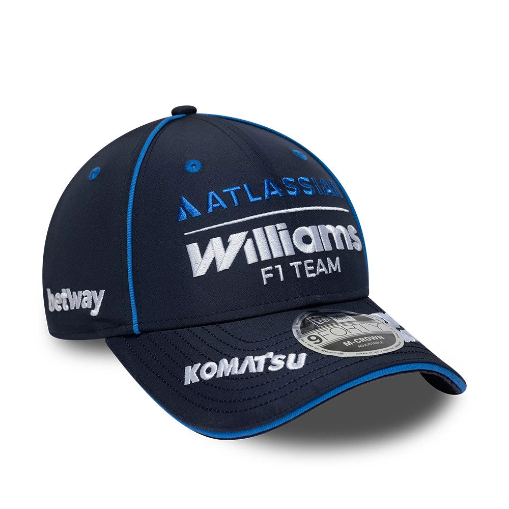 Williams Alex Albon Navy New Era 9FORTY M-Crown Adjustable Cap, three-quarter view showing the white Williams F1 Team logo embroidered on the front panel, blue on the visor edge, and a 9FORTY size sticker on the curved visor.